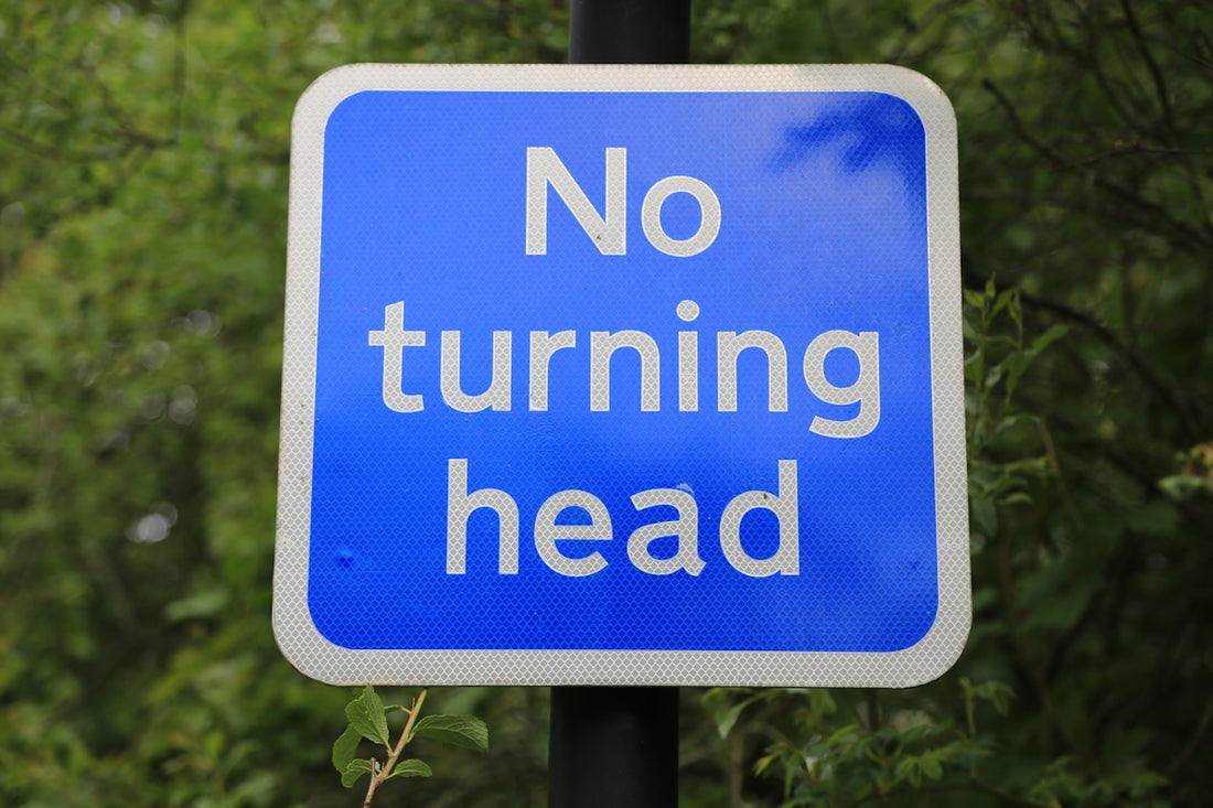 a blue and white sign that says no turning head